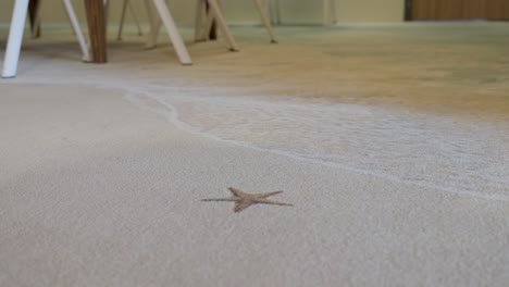 Low-orbiting-shot-of-a-star-imprint-on-a-fake-beach-flooring-in-a-house