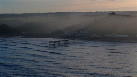 Establishing-Drone-Shot-of-Saltburn-by-the-Sea-Pier-on-Hazy-Day-UK
