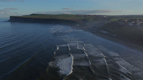 Establishing-Drone-Shot-of-Saltburn-by-the-Sea-and-Cliffs-at-High-Tide