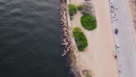 Aerial-view-of-a-coastal-park-with-a-rocky-pier-from-the-above-aerial-shot
