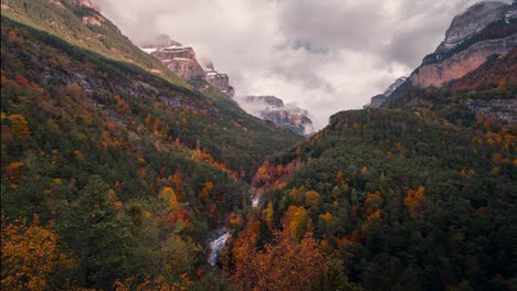 Ordesa-national-park-valley-on-a-cloudy-and-misty-winter-morning-timelapse-of-clouds-rolling-over-mountain-peaks-in-fall-autumn-season
