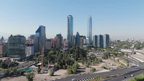 Aerial-View-Of-Gran-Torre-Santiago,-La-Portada-And-Titanium-Park-Buildings-On-Sunny-Day-With-Blue-Skies