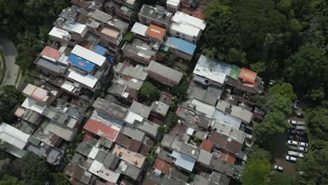 Drone-video,-bird's-eye-view-of-roofs-of-houses-in-Aguacatal-neighborhood,-western-Cali,-Colombia