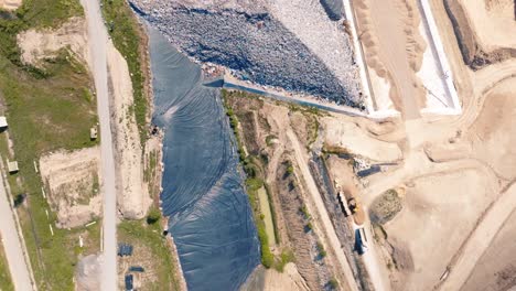 Birds-of-prey-fly-over-landfill-site,-fixed-drone-shot