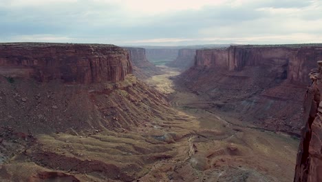 A-4K-drone-shot-over-the-"Fruit-Bowl"-during-sunset,-a-famous-highlining-area-found-deep-in-the-heart-of-Moab’s-share-of-the-Colorado-Plateau,-along-a-remote-section-of-Mineral-Canyon,-in-Utah