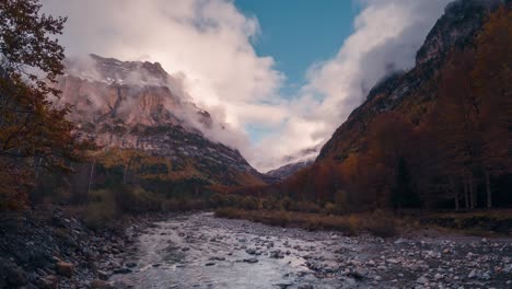 Ordesa-national-park-valley-mountains-and-river-on-a-cloudy-and-misty-winter-afternoon-timelapse-of-clouds-rolling-over-mountain-peaks-in-fall-autumn-season