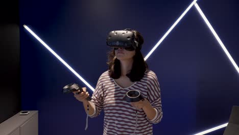 Hand-held-shot-of-a-middle-aged-woman-exploring-and-playing-with-the-new-VR-tech