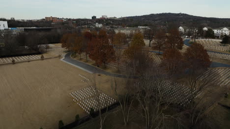 Flyover-Fayetteville-in-Autumn-fall,-Arkansas,-National-Cemetery,-forward