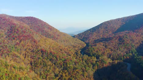 Aerial-pan-of-road-winding-through-Fall-colors-in-North-Georgia-Mountains
