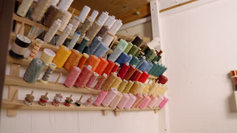 Cotton-thread-spools-on-wall-in-seamstress-studio