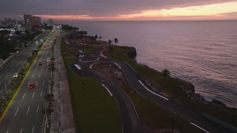 Cinematic-drone-shot-over-Martimo-Promenade-during-sunset-time-In-Santo-Domingo,-Dominican-Republic