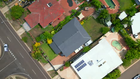 Top-down-aerial-drone-shot-of-small-houses-in-a-residential-neighbourhood