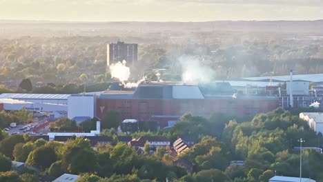 Steam-is-rising-above-the-offices-in-Old-Trafford,-Manchester
