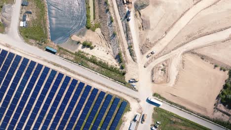 Aerial-view-of-a-solar-panel-installation-next-to-a-landfill-site-for-non-recycled-waste