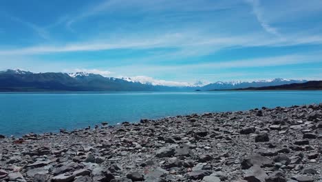 Dynamic-approach:-Moving-towards-Mount-Cook-over-rocks-in-captivating-stock-footage