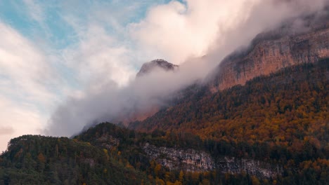 Close-up-timelapse-Ordesa-national-park-valley-on-a-cloudy-and-misty-winter-morning-timelapse-of-clouds-rolling-over-mountain-peaks-in-fall-autumn-season