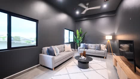 Interior-designed-moody-stylish-contemporary-modern-luxurious-cinema-media-room-or-small-lounge-entertainment-room-with-dark-grey-walls-modern-furniture
