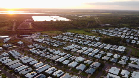 Stunning-sunset-sunrise-aerial-drone-pull-back-over-modern-new-residential-suburb