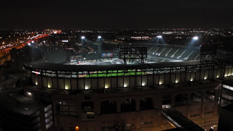 Aerial-rising-tilt-shot-in-front-of-the-illuminated-Guaranteed-Rate-Field,-in-Chicago