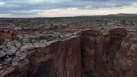 A-4K-rotating-drone-shot-of-the-"Fruit-Bowl",-a-famous-highlining-area-found-deep-in-the-heart-of-Moab’s-share-of-the-Colorado-Plateau,-along-a-remote-section-of-Mineral-Canyon,-in-Utah