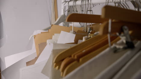 Sewing-pattern-templates-on-hangers-in-fashion-designer-studio