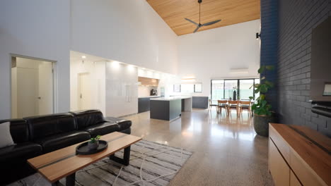 Offenes-Wohnzimmer-In-Moderner-Architektur-Mit-Holzdecke-Und-Luxuriöser-Küche