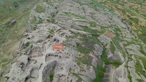 Ancient-rock-hewn-town,-Uplistsikhe,-in-eastern-Georgia,-aerial-perspective