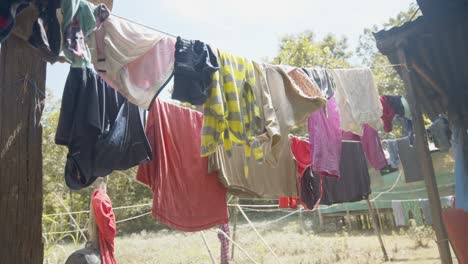 Sunlight-plays-on-fabrics-drying-the-wet-material-as-they-hang-in-muddled-rows