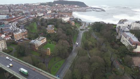 Wide-angle-drone-shot-of-Scarborough-bay-with-a-beautiful-cityscape-and-continuous-waves-at-river-bank-in-North-Yorkshire,-England