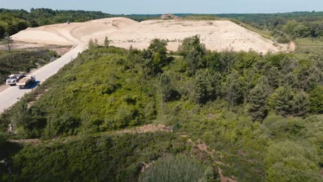 discovery-of-a-landfill-in-the-middle-of-the-forest,-wide-drone-shot-of-a-landfill-site