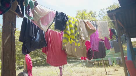 Colourful-clothes-on-garden-washing-line-sway-gently-in-the-drying-breeze