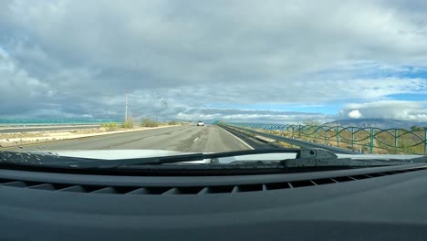 Point-of-view---Driving-on-a-quiet-expressway-thru-rural-Rincon-Valley-of-the-Sonora-Desert-on-cloudy-day-in-southern-Arizona