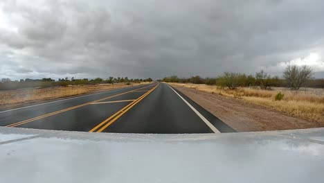 Point-of-view---Driving-on-a-rural-highway-in-the-Sonoran-Desert-on-cloudy-rainy-day-in-Arizona