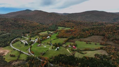 Houses-In-The-Foothills-Of-Mountain-With-Forest-In-Autumn