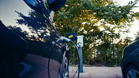 Electric-car-plugged-and-charging-at-a-charging-station