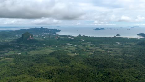 Lush-greenery-with-mountains-and-sea-in-the-distance-under-a-cloudy-sky,-dragon-Crest-Krabi-Thailand