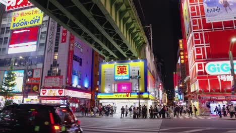 Establishing-shot-of-night-in-Akihabara-along-busy-night-road-through-center-of-otaku-and-anime-street