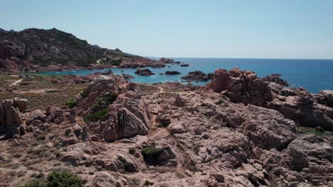 approach-reveal-aerial-shot-of-rocky-costline-in-sardinia-during-sunny-day