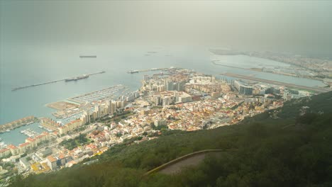 Panoramic-aerial-view-of-the-rock-of-Gibraltar,-roof-tops-and-the-port-of-Gibraltar,-Iberian-peninsula,-UK