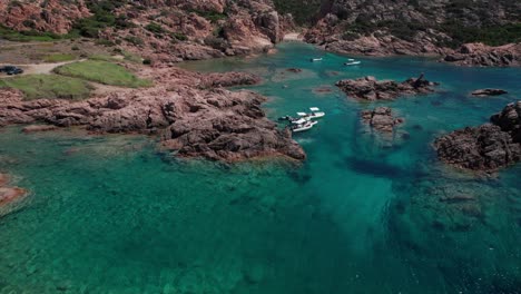 aerial-view-from-above-of-particular-rocky-area-of-Sardinian-sea-in-Italy-with-boats-anchored-in-place-of-protected-nature-while-enjoying-summer-season