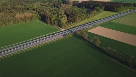 A-drone-approaches-a-roadway-that-runs-through-farmland