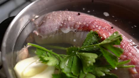 Stuffed-Flank-Steak-In-Pot-With-Water-And-Parsley-For-Boiling
