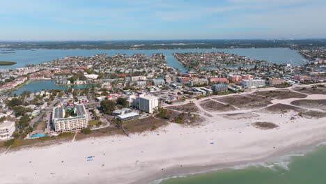 Aerial-drone-panning-view-of-beach-condos-and-house-on-Madeira-beach,-FL
