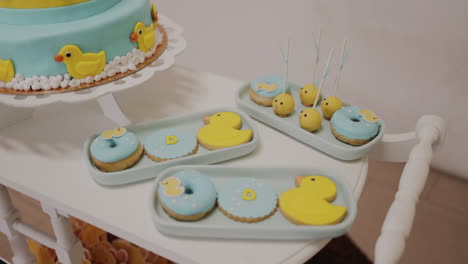 Duck-themed-cookies-and-cake-on-dessert-table