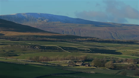 Establishing-Drone-Shot-of-Yorkshire-Dales-Farmland-with-Whernside-Behind