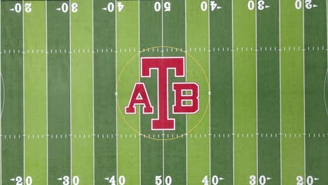 ATB-logo-on-green-American-football-field-grass-in-Anchor-Bay,-aerial-top-down-view