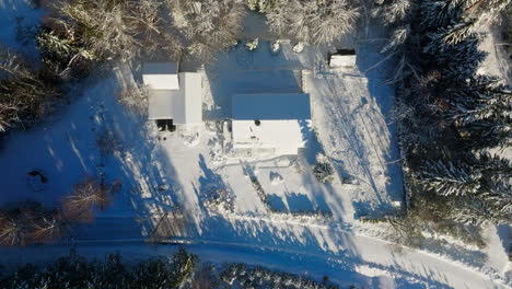Aerial-screwdriver-shot-above-partly-cleaned-Photovoltaic-system-on-a-snowy-house