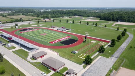 Anchor-Bay-High-School-stadium-with-running-track-and-football-field,-aerial-view
