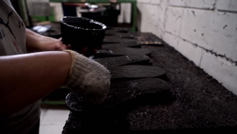 Closeup-of-worker-applying-polish,-wax-and-color-to-shoes-under-manufacturing
