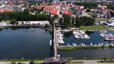 Gizycko-township-and-small-marina-with-boats-and-yachts,-aerial-view